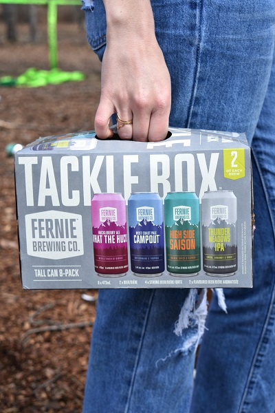 A person holding a pack of Tackle Box