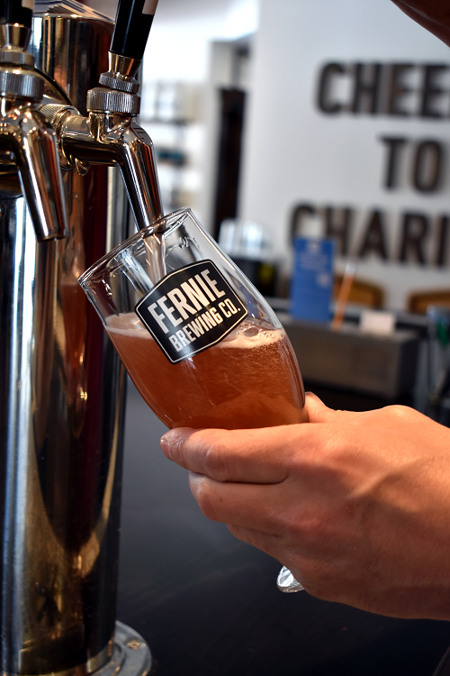 A pint of What the Huck® Berry Ale being poured.