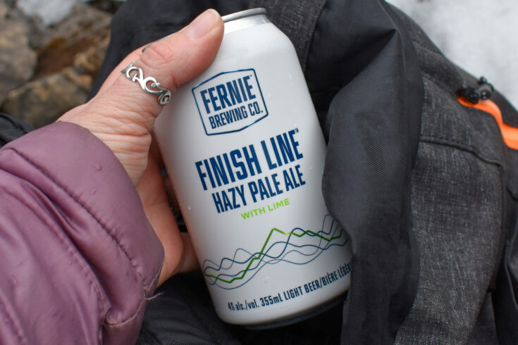Can of Finish Line Hazy Pale with Lime being pulled out of backpack