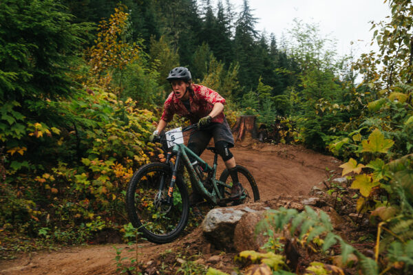 Micah Morris mountain biking in red shirt.