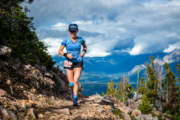 Abi Moore trail running up mountain.