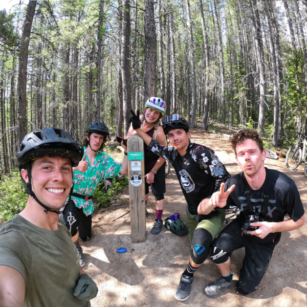 Group of bikers at summit of Project 9 trail in Fernie BC.