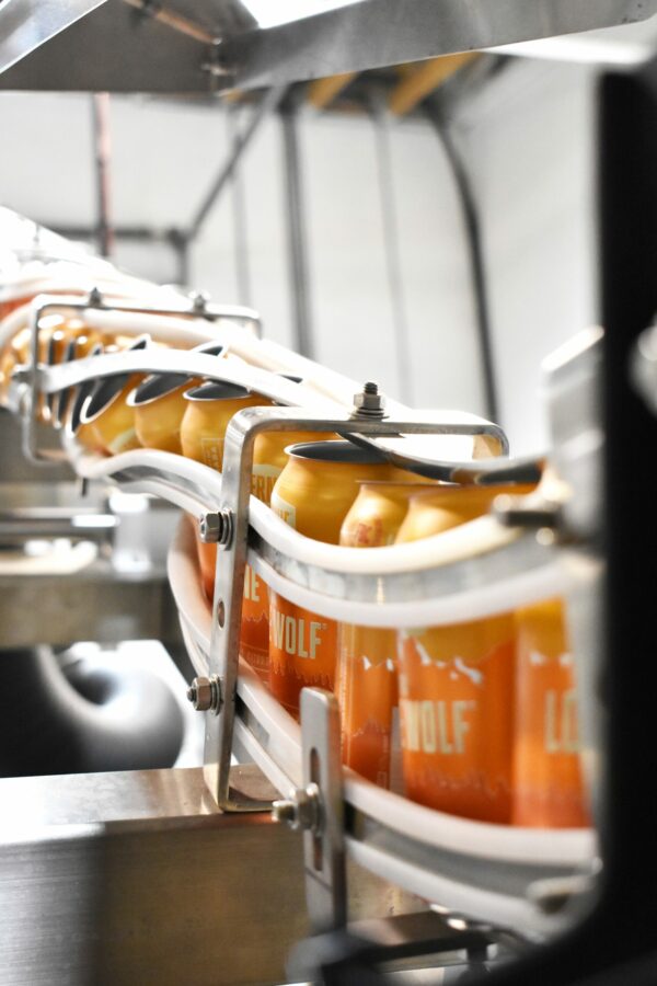 Row of beer going through a sustainable canning line