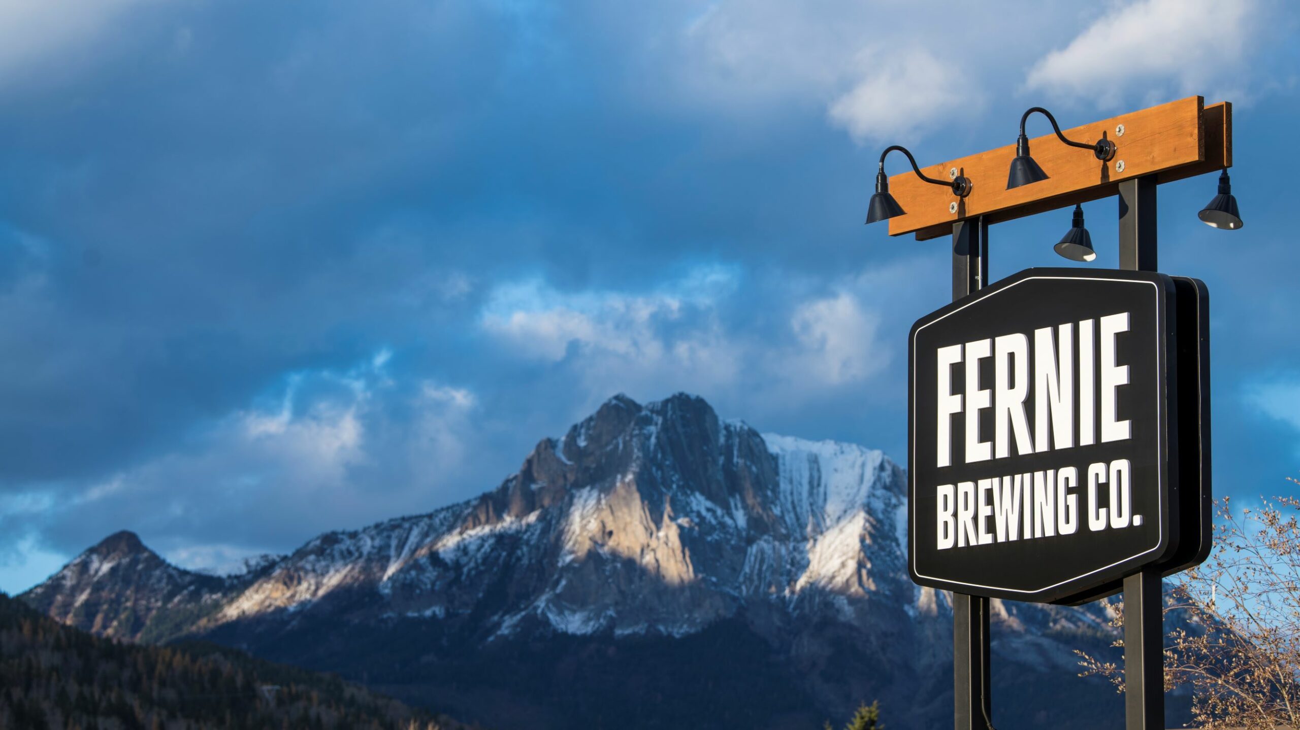 The Fernie Brewing Co. sign with a mountain in the background.