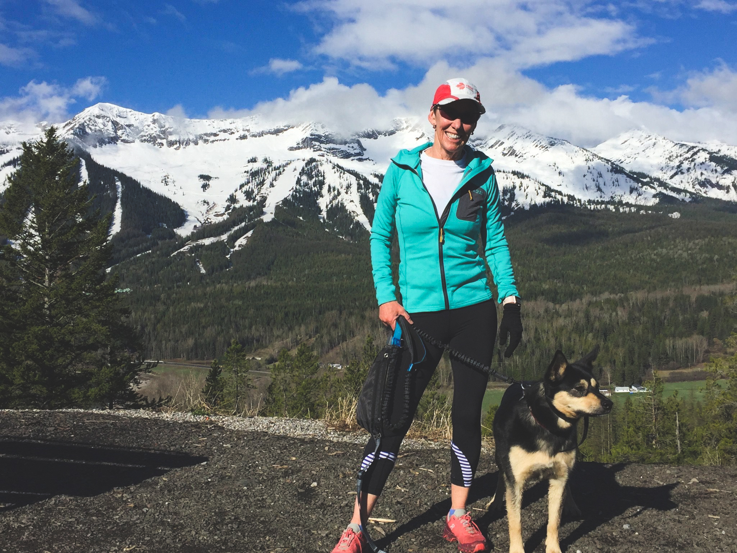 Sue and her dog on a mountain.