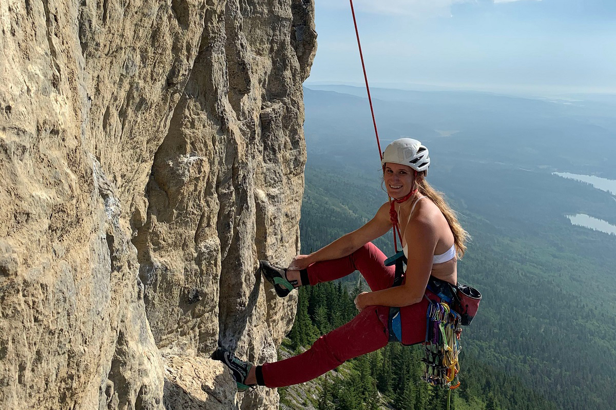 Jacqueline hanging during a rock climb.