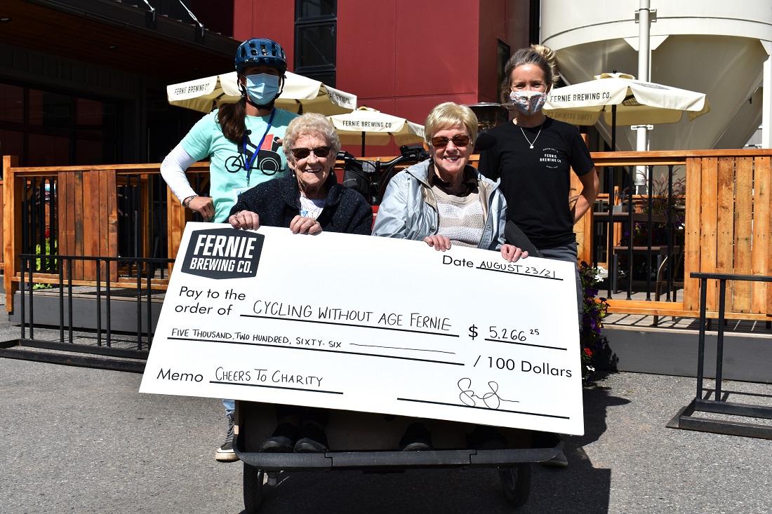 Cycling without age seniors accept donation cheque