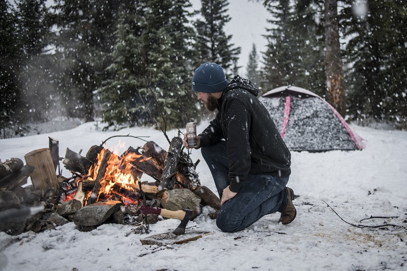 Man around a winter campfire