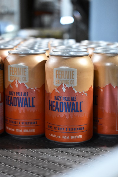 Headwall Hazy Pale Ale cans on a canning line