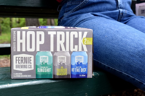 a hop trick six pack resting on a picnic table