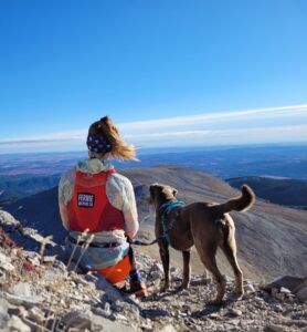 Suze and her dog on a mountain top