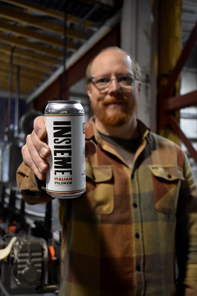 Mike holding up a can of Insieme