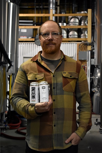 edsigner of the Insieme labels holding a 4-pack