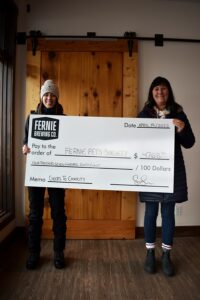 Rwo women holding up a cheque dedicated to the Fernie Pets Society