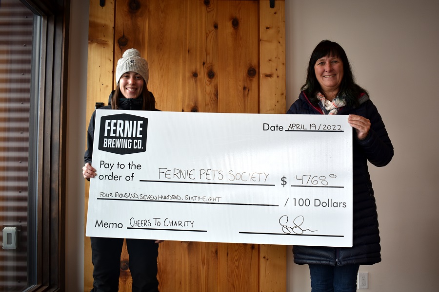 Women holding up a big cheque