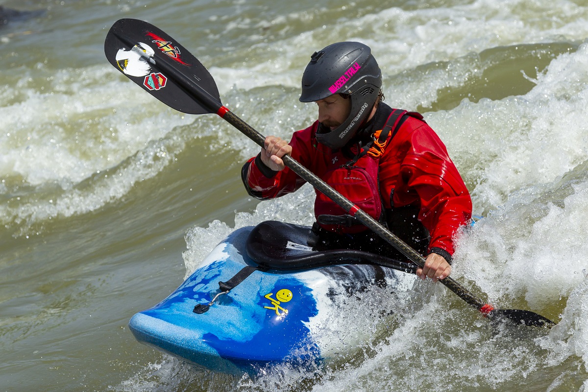 A man whitewater kayaking