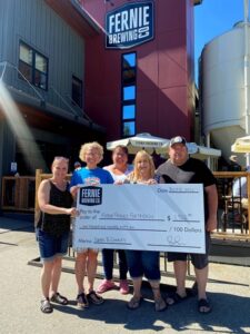 Fernie friends for Friends holding up a large donation cheque