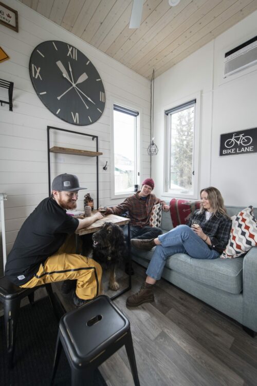 people in tiny home drinking beer