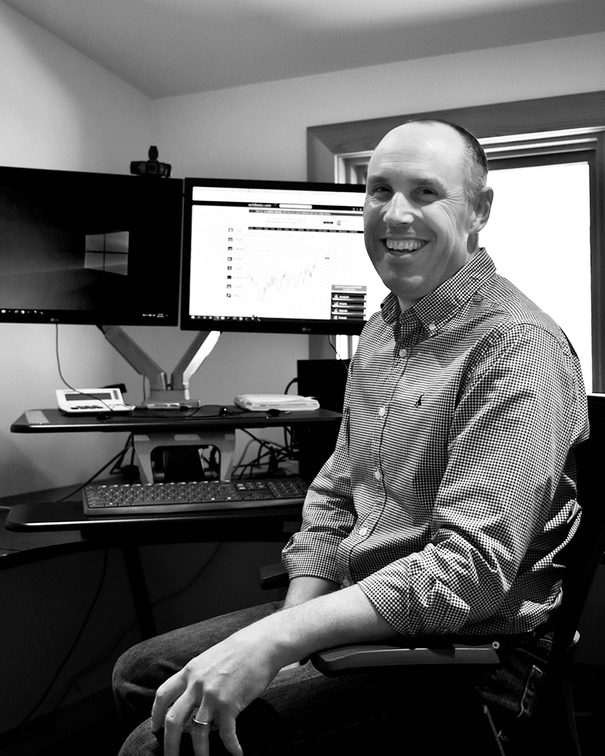 Mark Barron. Business Manager at Fernie Brewing Co., sitting at his desk.