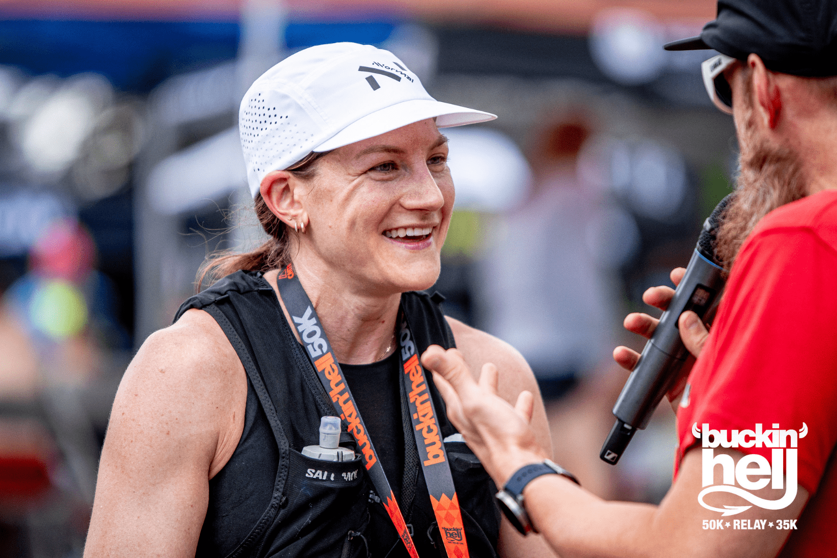 A woman receiving a medal after running a race.